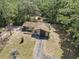 An aerial view showcasing the house nestled among the trees and a long driveway at 4467 Sw Channel Heights Ct, Dunnellon, FL 34431