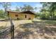 The backyard features a chain-link fence at 4467 Sw Channel Heights Ct, Dunnellon, FL 34431