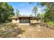The backyard shows a screened-in porch with chain-link fence at 4467 Sw Channel Heights Ct, Dunnellon, FL 34431