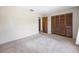 Bedroom featuring neutral walls, carpet, closet with wood slat doors and additional door at 4467 Sw Channel Heights Ct, Dunnellon, FL 34431