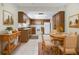Functional kitchen featuring wood cabinets, white appliances, and tile flooring with dining area at 4467 Sw Channel Heights Ct, Dunnellon, FL 34431