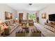 Cozy living room with plush furniture, decor, and ample natural light at 4467 Sw Channel Heights Ct, Dunnellon, FL 34431