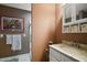 Cozy bathroom featuring a vanity with granite countertop, and a framed picture, alongside a glass enclosed shower at 4673 Se 115Th St, Belleview, FL 34420