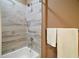 Bathroom with tiled shower and tub combination and neutral colored walls at 4673 Se 115Th St, Belleview, FL 34420