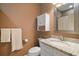 Bathroom features a granite countertop vanity with decorative mirror and white cabinets at 4673 Se 115Th St, Belleview, FL 34420
