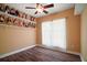 Bedroom with wood floors and shelves of dolls at 4673 Se 115Th St, Belleview, FL 34420