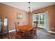 Dining room is furnished with wood table and chairs and features a large window at 4673 Se 115Th St, Belleview, FL 34420