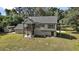 Rear exterior showcasing the two-story house design with attached deck overlooking the backyard at 4673 Se 115Th St, Belleview, FL 34420