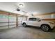Spacious three-car garage with a white truck, offering plenty of parking and storage space at 4673 Se 115Th St, Belleview, FL 34420