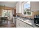 Bright kitchen features granite countertops and stainless steel appliances; dining area adjacent at 4673 Se 115Th St, Belleview, FL 34420
