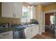 Bright kitchen features stainless steel appliances, granite countertops and white cabinets at 4673 Se 115Th St, Belleview, FL 34420