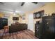 Inviting living room featuring hardwood floors, ceiling fan and multiple safes for secure storage at 4673 Se 115Th St, Belleview, FL 34420