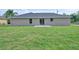 Well-maintained backyard with lush green grass and the back of the house in view at 490 Marion Oaks Golf Way, Ocala, FL 34473