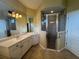 Bathroom featuring a walk-in shower, ample countertop space, and a large mirror at 4940 Sw 63Rd Loop, Ocala, FL 34474