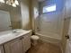 Bathroom featuring a shower-tub combo, white vanity, and neutral tile flooring at 4940 Sw 63Rd Loop, Ocala, FL 34474