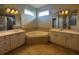 A primary bathroom featuring dual vanities, mirrors, and soaking tub underneath clerestory windows at 4940 Sw 63Rd Loop, Ocala, FL 34474