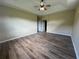 Large bedroom with hardwood floors and a tray ceiling, offering plenty of space at 4940 Sw 63Rd Loop, Ocala, FL 34474