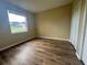 Bedroom featuring vinyl flooring, a window view, and a closet at 4940 Sw 63Rd Loop, Ocala, FL 34474