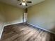 Bedroom featuring vinyl flooring, a ceiling fan, and neutral colored walls at 4940 Sw 63Rd Loop, Ocala, FL 34474