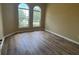 Sunlit bedroom with arched windows, wood-look flooring, and neutral walls creating a serene atmosphere at 4940 Sw 63Rd Loop, Ocala, FL 34474