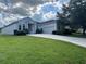 Charming single-story home featuring a well-manicured lawn and a two-car garage at 4940 Sw 63Rd Loop, Ocala, FL 34474