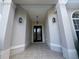 Inviting front door framed by stylish columns and decorative sconces at 4940 Sw 63Rd Loop, Ocala, FL 34474