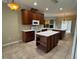 This kitchen has a center island, stainless steel appliances, and dark wood cabinets at 4940 Sw 63Rd Loop, Ocala, FL 34474