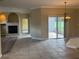 Bright living room featuring a fireplace, tile flooring, and sliding glass door for outdoor access at 4940 Sw 63Rd Loop, Ocala, FL 34474