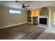 Well-lit living room with fireplace, hardwood flooring, and arched niches at 4940 Sw 63Rd Loop, Ocala, FL 34474