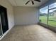 Enclosed tile patio with screening and a ceiling fan offering an outdoor living space at 4940 Sw 63Rd Loop, Ocala, FL 34474