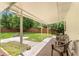 Back porch with chairs and a view of the spacious, fenced backyard at 5005 Ne 22Nd Ave, Ocala, FL 34479