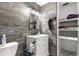 Bathroom featuring hexagon tile floors, a wood accent wall and a built in towel rack at 5005 Ne 22Nd Ave, Ocala, FL 34479