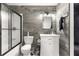 Well-lit bathroom featuring hexagon tile floors, a wood accent wall and a glass shower door at 5005 Ne 22Nd Ave, Ocala, FL 34479