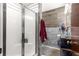 Bathroom featuring tiled walls, a glass shower door and a metal towel rack at 5005 Ne 22Nd Ave, Ocala, FL 34479