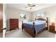 Bright bedroom with a ceiling fan, two windows and a cozy bed with wood frame at 5005 Ne 22Nd Ave, Ocala, FL 34479