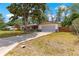 Inviting home with a well-manicured lawn, a driveway, a two-car garage, and a charming front porch area at 5005 Ne 22Nd Ave, Ocala, FL 34479