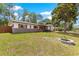Charming one-story home featuring a landscaped yard, decorative shutters, and a cozy front porch sitting area at 5005 Ne 22Nd Ave, Ocala, FL 34479