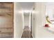 Hallway featuring laminate floors and neutral walls, offering a bright and airy feel at 5005 Ne 22Nd Ave, Ocala, FL 34479
