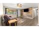 Comfortable living room with wood accent wall and laminate floors at 5005 Ne 22Nd Ave, Ocala, FL 34479