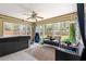 Bright sunroom with a hot tub, tile floor, ceiling fan, and backyard view at 5005 Ne 22Nd Ave, Ocala, FL 34479