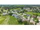 Scenic aerial view of a residential neighborhood with lush greenery, golf course, and beautiful single-Gathering homes at 5007 Kelso St, Leesburg, FL 34748