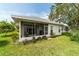 Exterior of home showcasing a screened in lanai with seating, perfect for enjoying a relaxing outdoor space at 5007 Kelso St, Leesburg, FL 34748