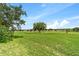 Relax and unwind in the grassy backyard, surrounded by serene views and mature trees at 5007 Kelso St, Leesburg, FL 34748