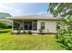 A nice screened-in patio area with a view of the spacious, well-maintained backyard at 5007 Kelso St, Leesburg, FL 34748