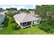 An aerial view of a home's back yard with a screened-in patio and well maintained lawn at 5007 Kelso St, Leesburg, FL 34748