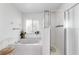 Bright bathroom offering a soaking tub, window and a glass enclosed shower at 5007 Kelso St, Leesburg, FL 34748
