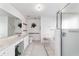 Bright bathroom featuring double vanity with spacious counter, large mirror, and walk-in shower at 5007 Kelso St, Leesburg, FL 34748