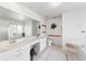 Bright bathroom with double vanity with spacious counters, soaking tub, walk-in shower and toilet at 5007 Kelso St, Leesburg, FL 34748