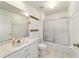 Hall bathroom featuring tiled floors, single sink vanity with a shower and tub combo at 5007 Kelso St, Leesburg, FL 34748