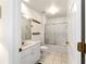 Hall bathroom featuring tiled floors, single sink vanity with a shower and tub combo at 5007 Kelso St, Leesburg, FL 34748